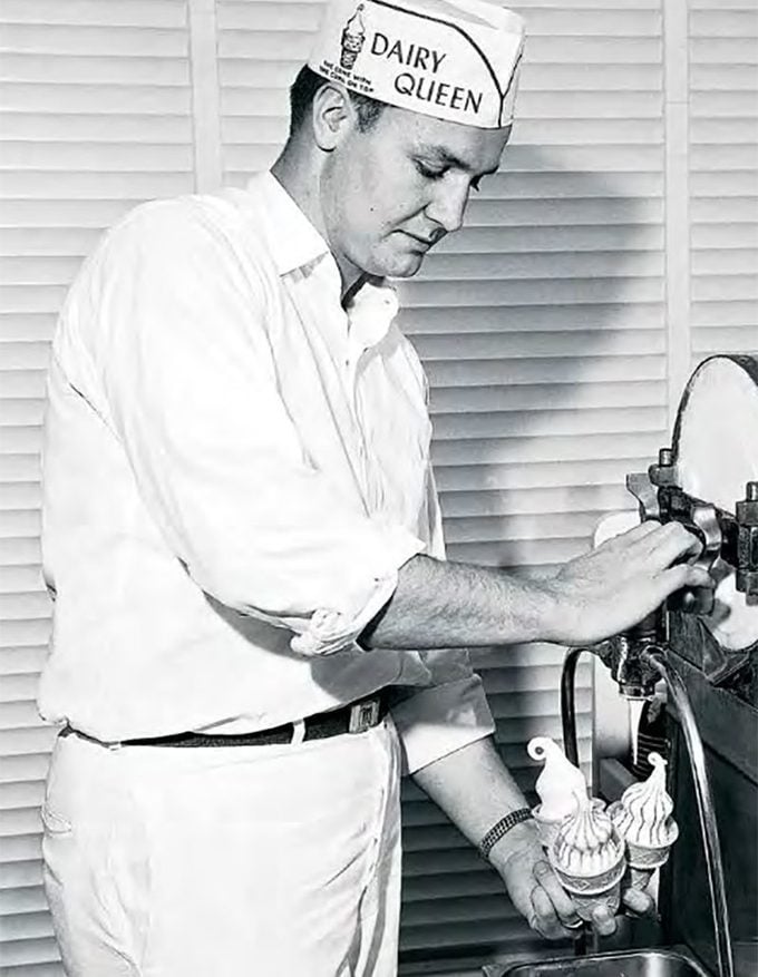 Old photo of an employee using an ice cream machine.